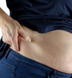 woman pinching hip fat